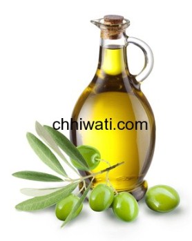 Branch with olives and a bottle of olive oil isolated on white